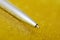 Silver fountain pen lies on a bright golden surface. Signing a contract or permit. Time for study and business. Close-up. Shallow