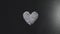 Silver glitter arrange to heart shape on black background with flying light
