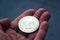 Silver gold ripple coin in hand, cryptocurrency investing concept