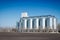 Silver Grain Silos with blue sky in background