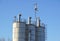 Silver Grain Silos with blue sky in background