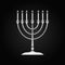 Silver Hanukkah menorah icon on black background