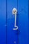 Silver hook on blue wooden door, practical decorative element, v