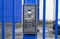 Silver intercom buzzer on a blue gate
