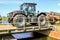 Silver Jcb fastrac parked up in bridge with roller