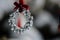 Silver Jingle Bell Wreath Christmas Ornament Decorating an Outdoor Tree