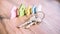 Silver Keychain in front of colourful miniature symbol of houses laying on the wooden surface