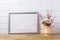 Silver landscape frame mockup with chamomile and purple flowers