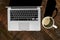 Silver Laptop and Foamy Latte Outdoors on Wooden Table