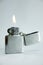 Silver lighter with flame.