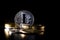 Silver litcoin with various physical metal coins on dark background. Cryptocurrency concepts
