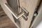 Silver matte door handle on an oak wooden door