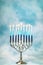 A silver menorah for the Jewish holiday Hanukkah with burning glowing eight candles