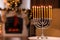 Silver menorah in room with fireplace, space for text. Hanukkah symbol