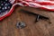 silver metal handcuffs and police nightstick near US flag on wooden surface