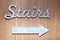 Silver metal letters, pointer of stairs sign on the wall hotel, lobby. Concept sign, cursor, inscription at five star hotel,