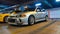 Silver Mitsubishi Lancer with Lancer Evolution 4 bodykit in an underground car event