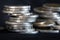 Silver money coin stacking on dark background
