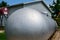 Silver painted liquid propane tank on rural property