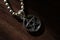 Silver Pentagram charm old necklace on a dark brown wooden surface