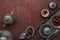 Silver plates with date fruits, Arabic coffee pot and cups on the dark red-brown wooden background. Ramadan background. Ramadan Ka