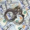 Silver police handcuffs lies on a many dollar bills