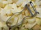 Silver potato peeler and chopped and peeled potatoes