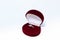 Silver ring with purple gemstone in a red jewelry box on white background