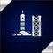 Silver Rocket launch from the spaceport icon isolated on dark blue background. Launch rocket in space. Vector
