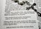 Silver rosary on open bible overMatthew 27:35 crucifixion text