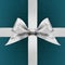 Silver satin ribbon bow on blue background