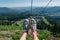 Silver shoes on feet during travel on mountain ski lift at summer time