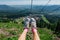 Silver shoes on feet during travel on mountain ski lift at summer time