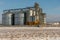 Silver silos against the blue sky in winter. Grain storage in winter at low temperatures. Production for processing, drying,
