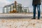 Silver silos in winter, wheat field covered with snow. The head of the agro-industrial complex stands near the plant for