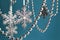 Silver snowflakes with a garland hang on a blue background