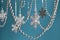 Silver snowflakes with a garland hang on a blue background