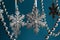 Silver snowflakes with a garland hang on a blue background