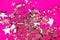 Silver sparkles on pink background.