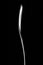 Silver spoon on pure black background