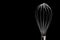 A silver stainless steel whisk