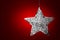 Silver Star Christmas Ornament Over Red Leather