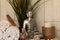 Silver statue of Buddha and spa essentials near the plant for aromatherapy