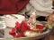 Silver statue of lord Ganesha surrounded by red rose petals for prayer