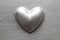 Silver statuette in the shape of hearts on a metal plate