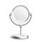 Silver table mirror with rotating circle top standing isolated on white background