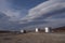 Silver tanks and the sky with lenticular clouds.