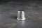 Silver thimble on grey table. Sewing accessory