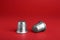 Silver thimbles on red background. Sewing accessory