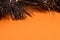 Silver tinsel on a orange background with space for text